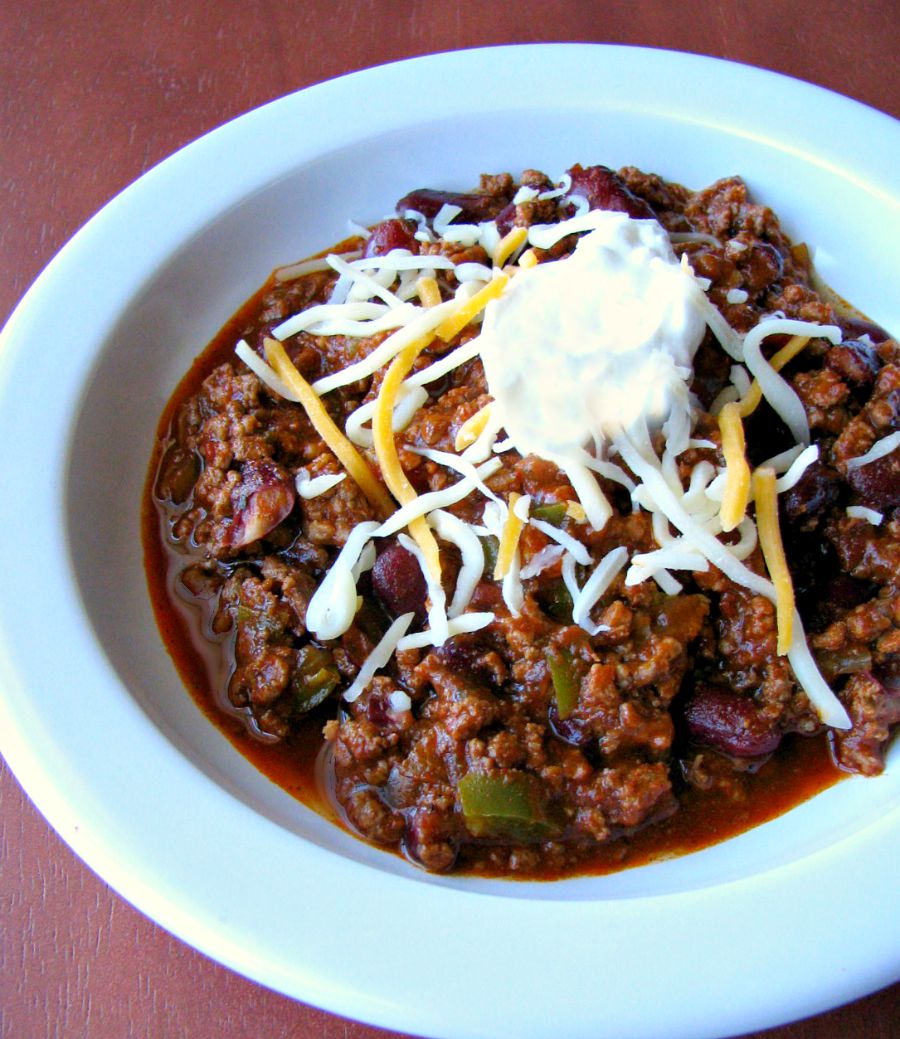 Spicy ground beef, slow cooker, award winning chili! Just brown the ground beef, put it in a slow cooker, add some delicious beans, veggies, and spices and cook! Simple, easy, delicious!