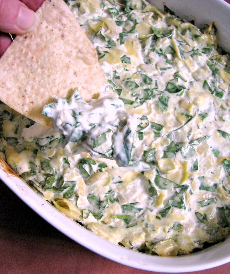 Spinach Artichoke Dip, made with fresh or frozen spinach, canned artichokes, cream cheese, and Gouda cheese, then baked or cooked in the slow cooker.