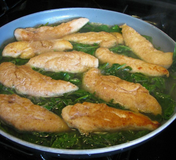 Chicken and Spinach in a skillet for Skillet Chicken with Spinach and Avocado recipe. 