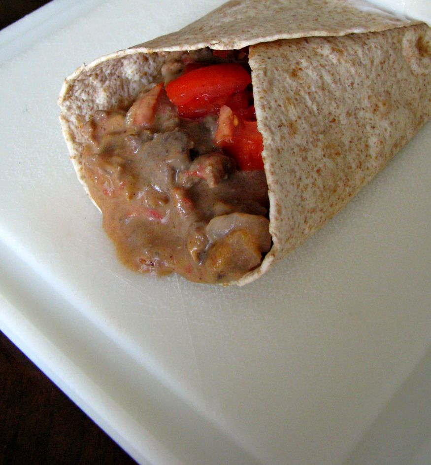 Simmered ground beef in a cheesy sauce, topped with diced fresh tomatoes and wrapped in a flour tortilla. Mexican fast food at home! 