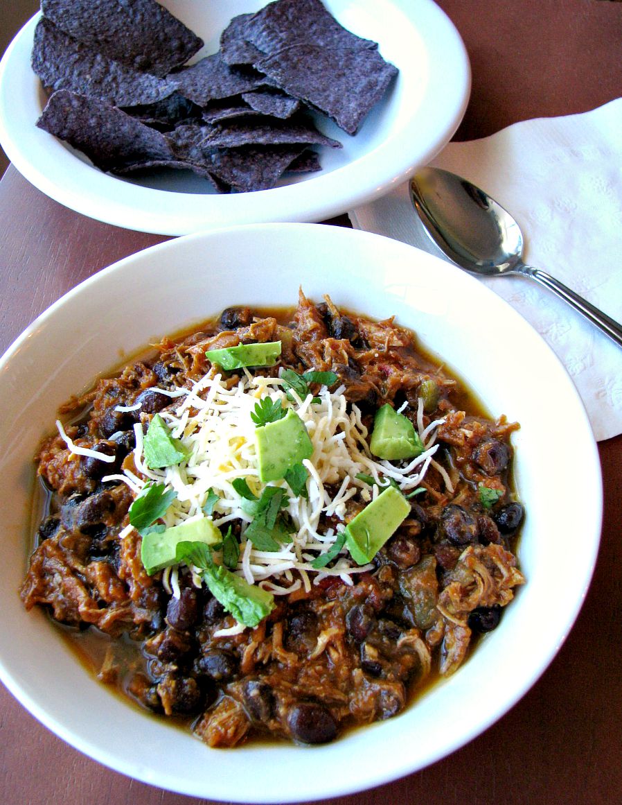 Southwest Chicken Pumpkin Chili made in the slow cooker with shredded chicken breasts, black beans, hot salsa, and pumpkin puree simmered in chicken stock. This chili is full of flavor, not too spicy, and healthy! 