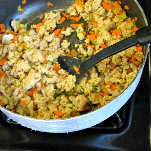 Browning ground chicken, carrots, and celery. 