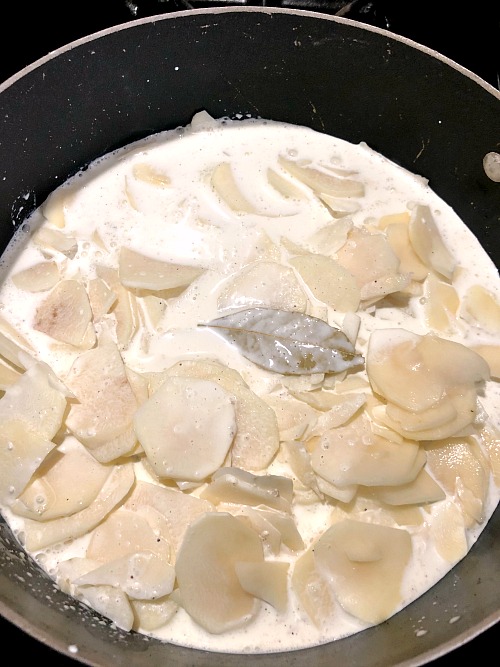 photo of potatoes in a pot covered with cream