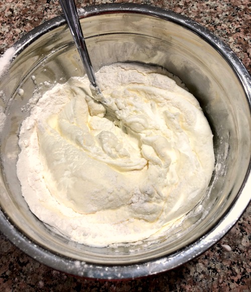 Sour cream and flour in a metal bowl 