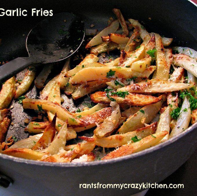 Homemade French Fries baked in the oven until crisp and finished with garlic butter and Parmesan cheese. These Easy Garlic Fries will be a hit with all but the biggest garlic haters!