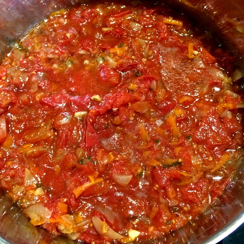 Photo of fully cook Slow Cooker Marinara Sauce in a blue slow cooker pot