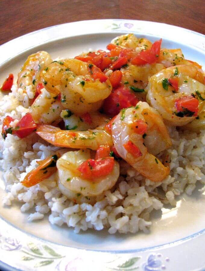 Quick and easy Shrimp and Bell Pepper Skillet with scallions, parsley, and black pepper in a butter sauce served over brown rice.