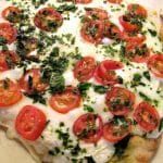 Photo of Margherita Naan Pizza on a light colored baking sheet.