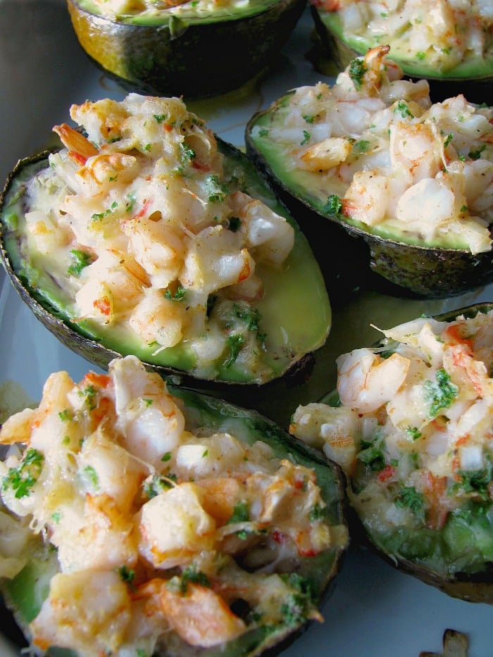 photo of a baking dish of baked seafood stuffed avocados