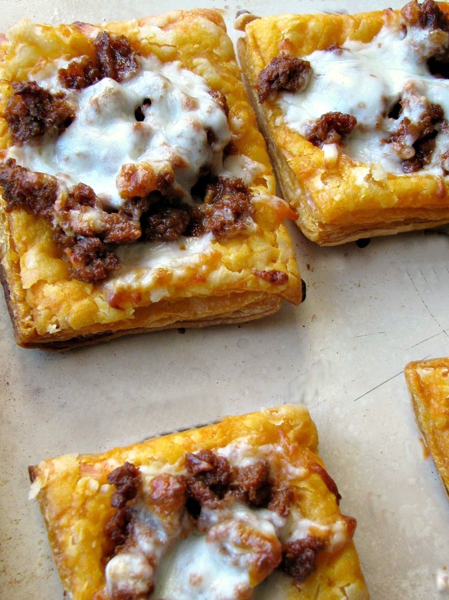 Photo of Cheesy Mexican Chorizo Puff Pastry Tarts on a baking sheet