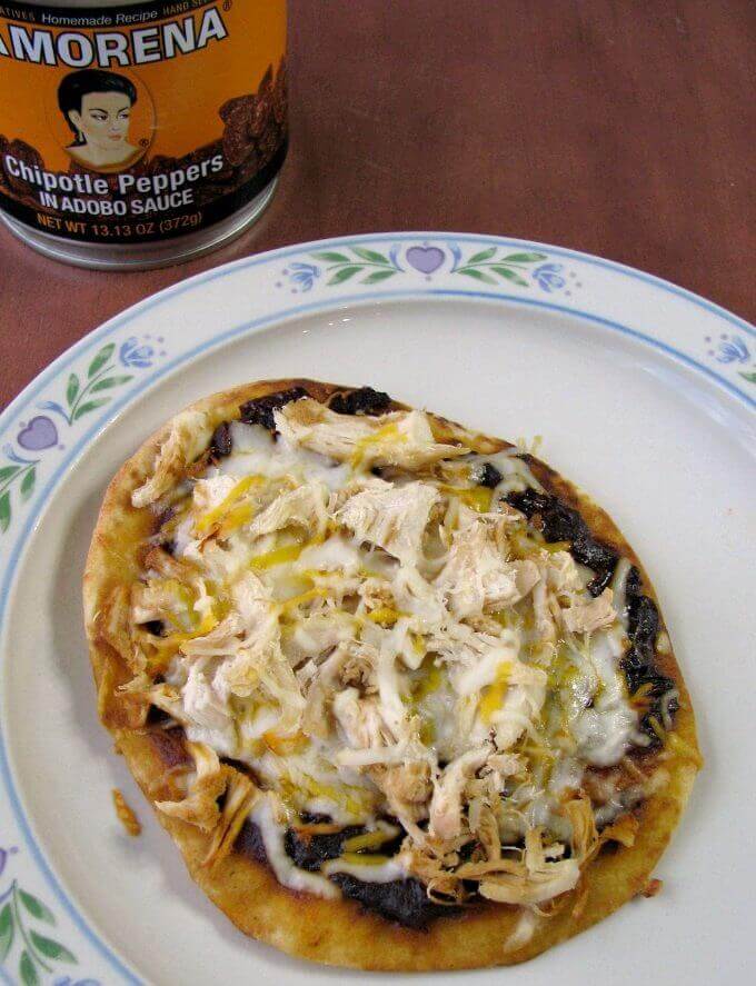 Chicken Naan Pizza is easy to make, with diced cooked chicken, chipotle peppers in adobo, Mexican and mozzarella cheeses on top of naan flatbreads.