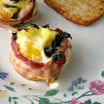 Sunny side up eggs in a bacon cup filled with diced jalapeno and shredded cheese, topped with more cheese and chopped basil, these Bacon Jalapeno Egg Cups are great for a weekend breakfast, or for a party brunch. 