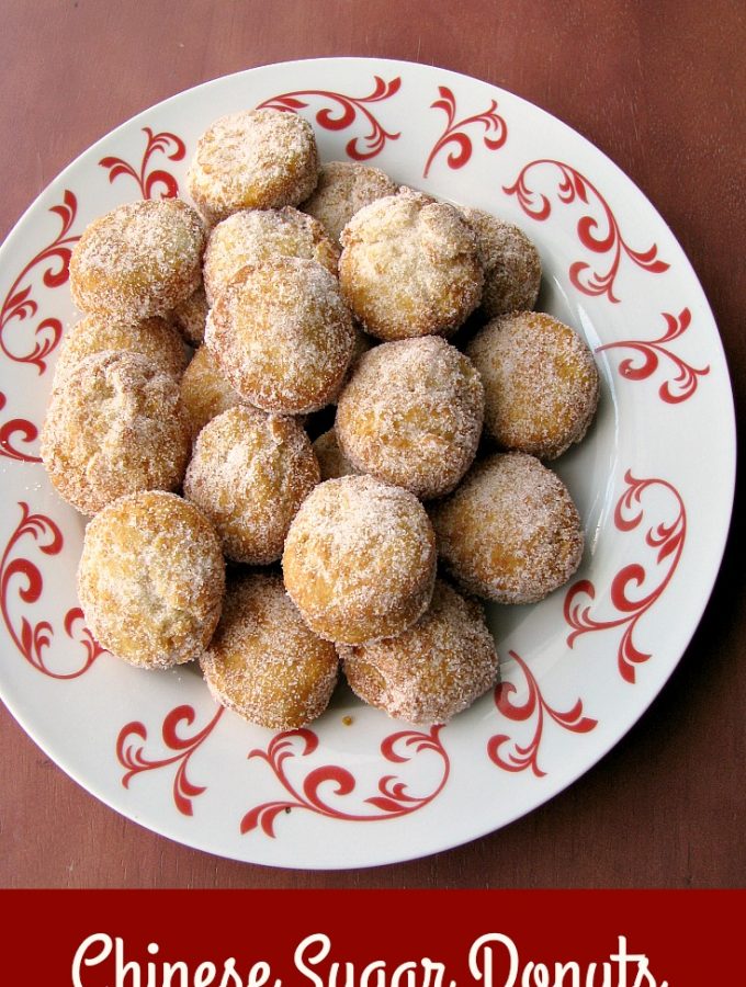 Photo of a plate of Chinese Sugar Donuts on a white and red plate