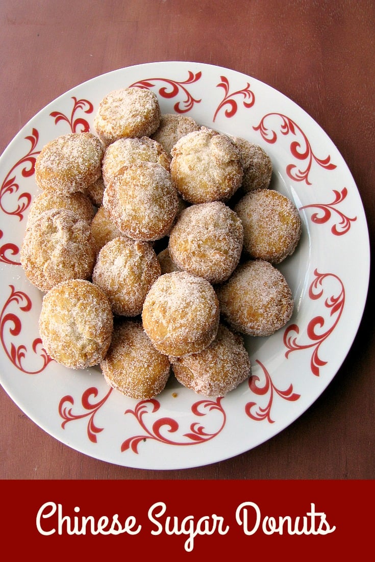 Photo of a plate of Chinese Sugar Donuts on a white and red plate 