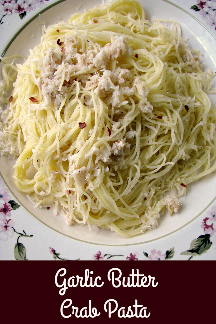 Photo of Garlic Butter Crab Pasta on a white plate with the title written at the bottom