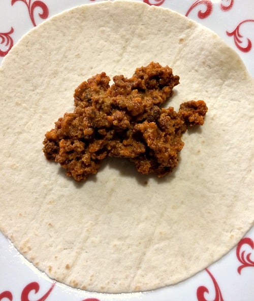 Photo of chorizo mixture on an open tortilla 