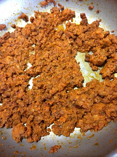 Photo of cooked chorizo mixed with shredded cheese and pumpkin puree 