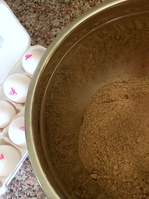 Photo of cake mix in a mixing bowl with a carton of Eggland's Best Eggs open next to it. 