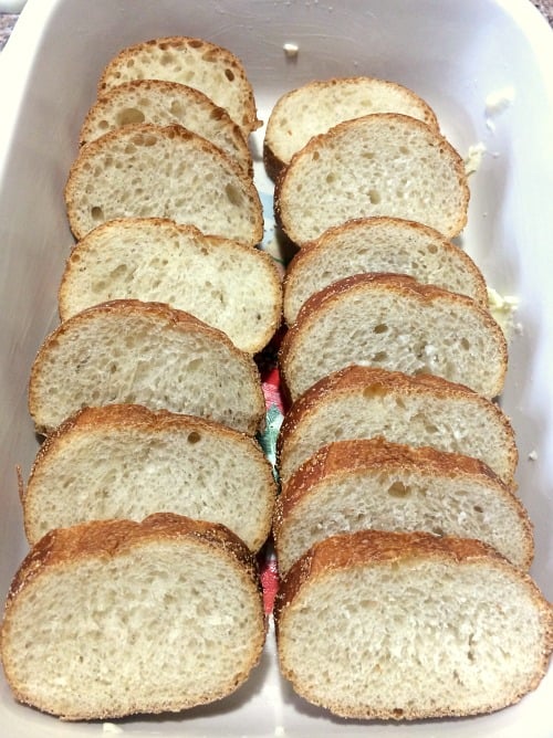 Photo of sliced French bread in a baking dish 