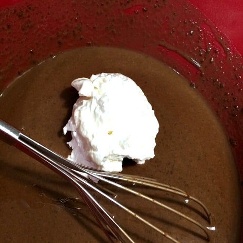 Photo of whipped cream on top of prepared chocolate eggnog 