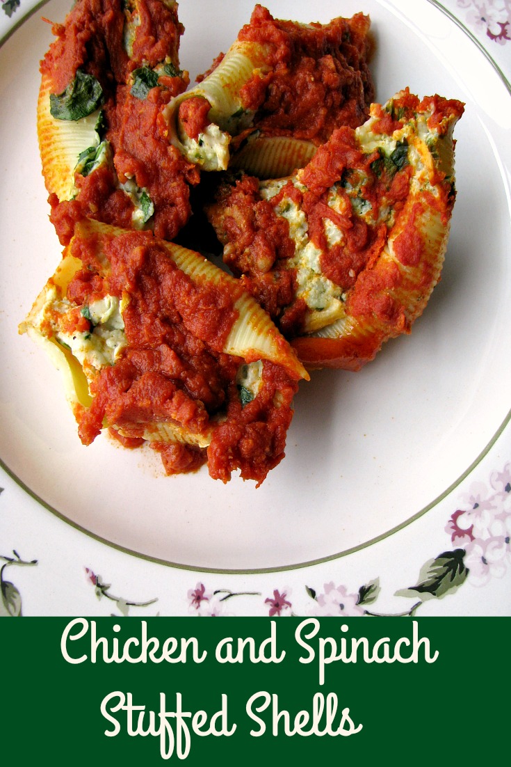 Photo of four Chicken and Spinach Stuffed Shells on a white plate with flower trim