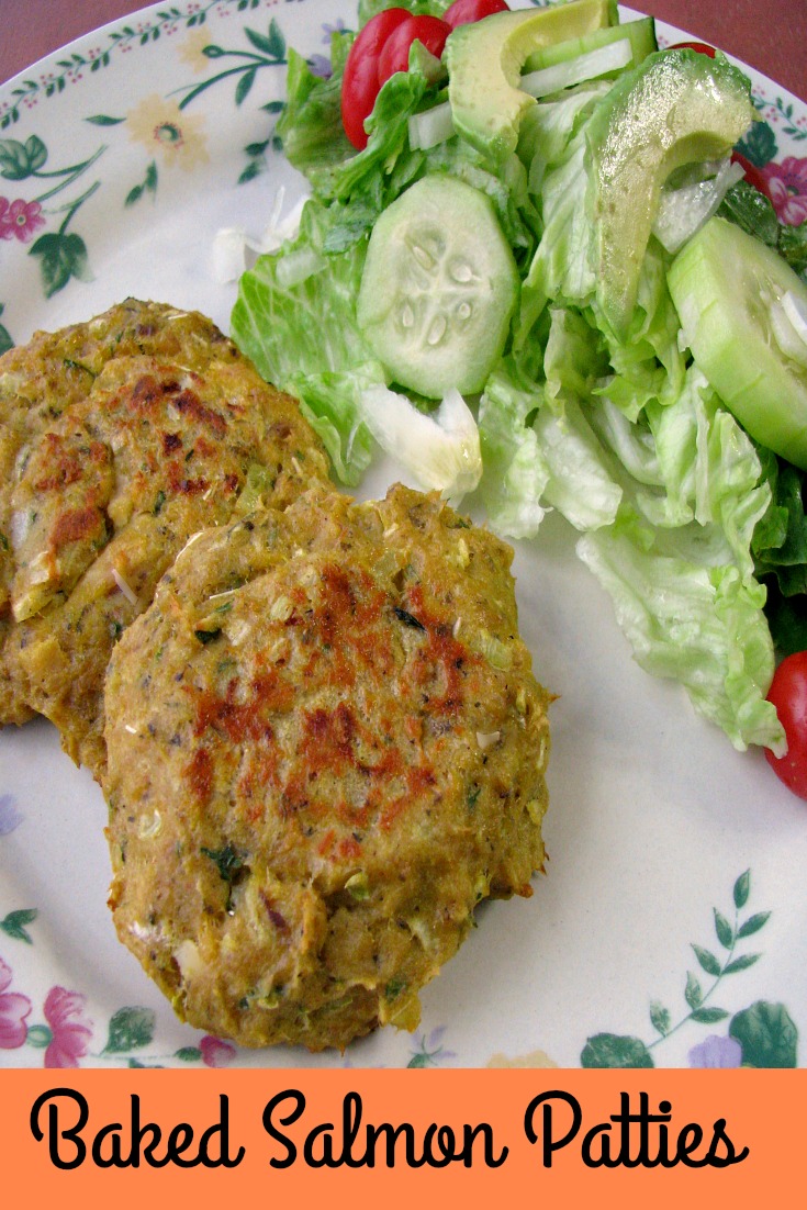 Photo of a plate of two Baked Salmon Patties on the left and a mixed house salad on the right 
