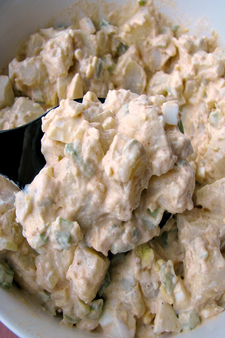 Close up photo of Quick and Easy Potato Salad on a serving spoon 
