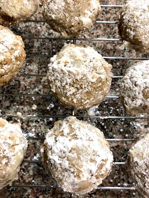 photo of powdered sugar coated cookies on a wire rack 