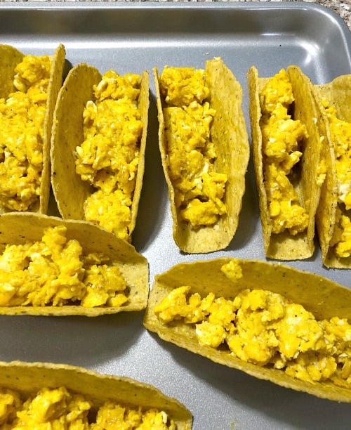 photo of taco shells filled with scrambled eggs 