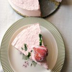 photo of sliced Frozen Strawberry Yogurt Pie on a plate next to the whole pie