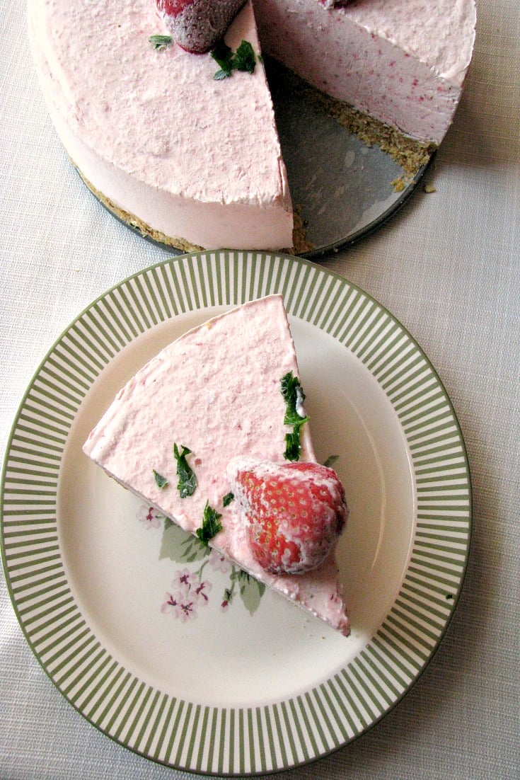 photo of sliced Frozen Strawberry Yogurt Pie on a plate next to the whole pie 