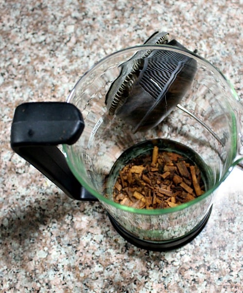 photo of ground spices and loose tea in a French press