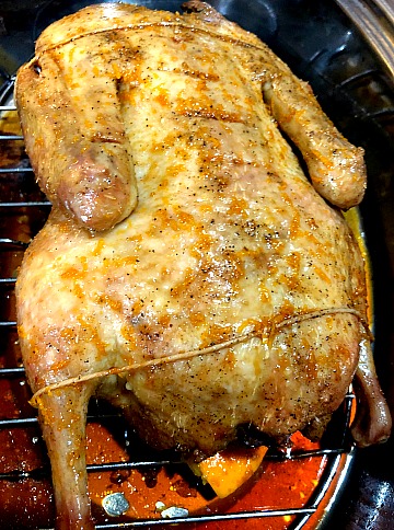 photo of a whole duck basted with an orange soy glaze