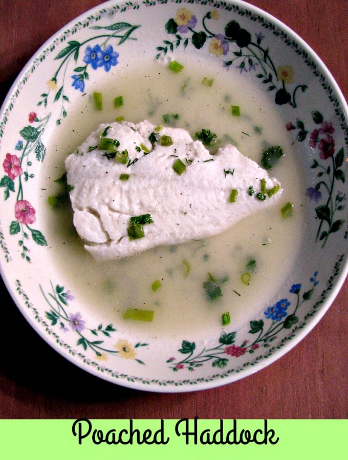 photo of a flower trimmed bowl with a piece of Poached Haddock in Herbed Broth