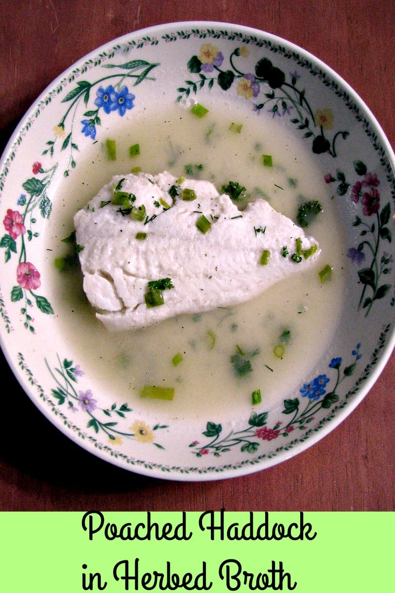 photo of a flower trimmed bowl with a piece of Poached Haddock in Herbed Broth
