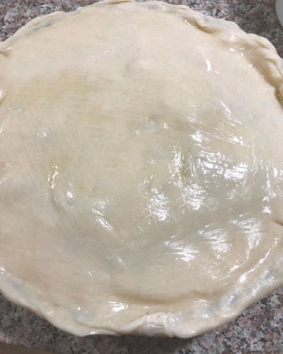 photo of unbaked pie crust brushed with egg white