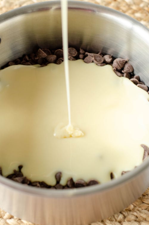 photo of condensed milk being added to chocolate chips