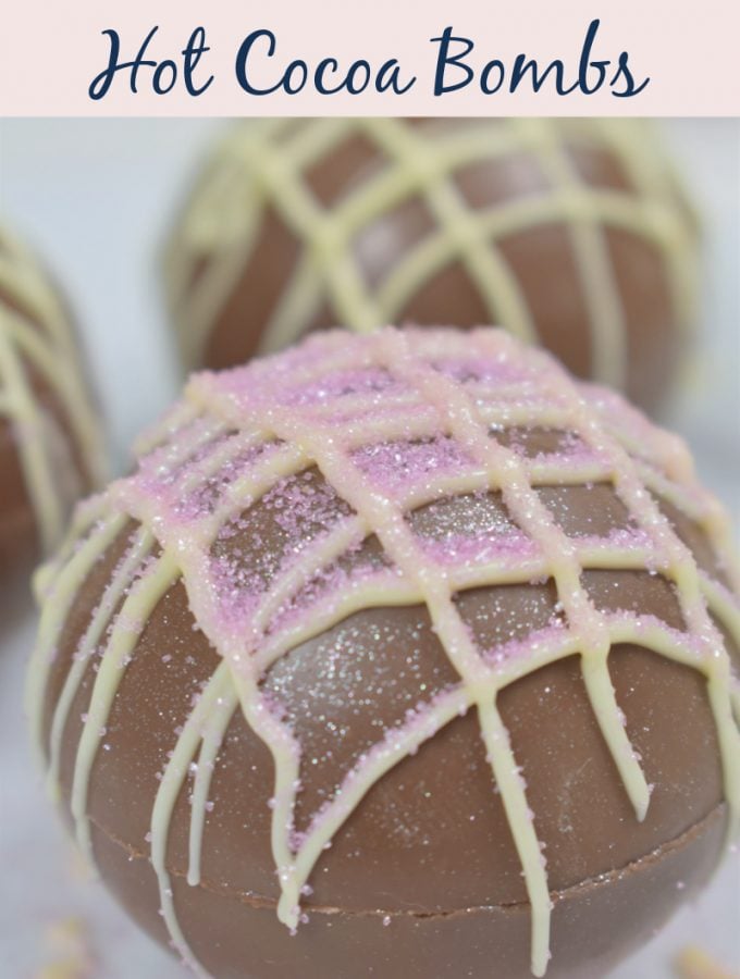photo of hot chocolate bombs decorated with glitter and melted colored chocolate