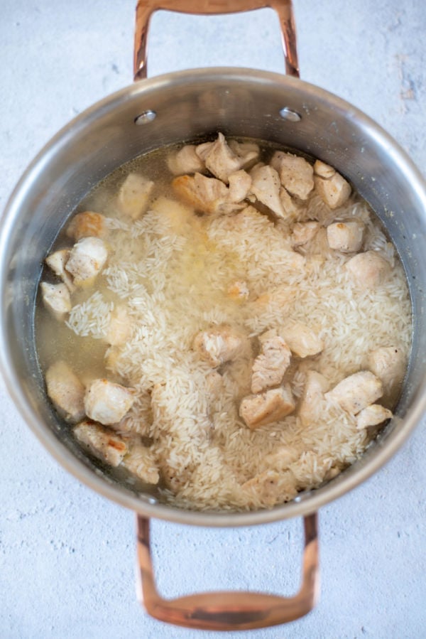 diced chicken broth and rice in a pot